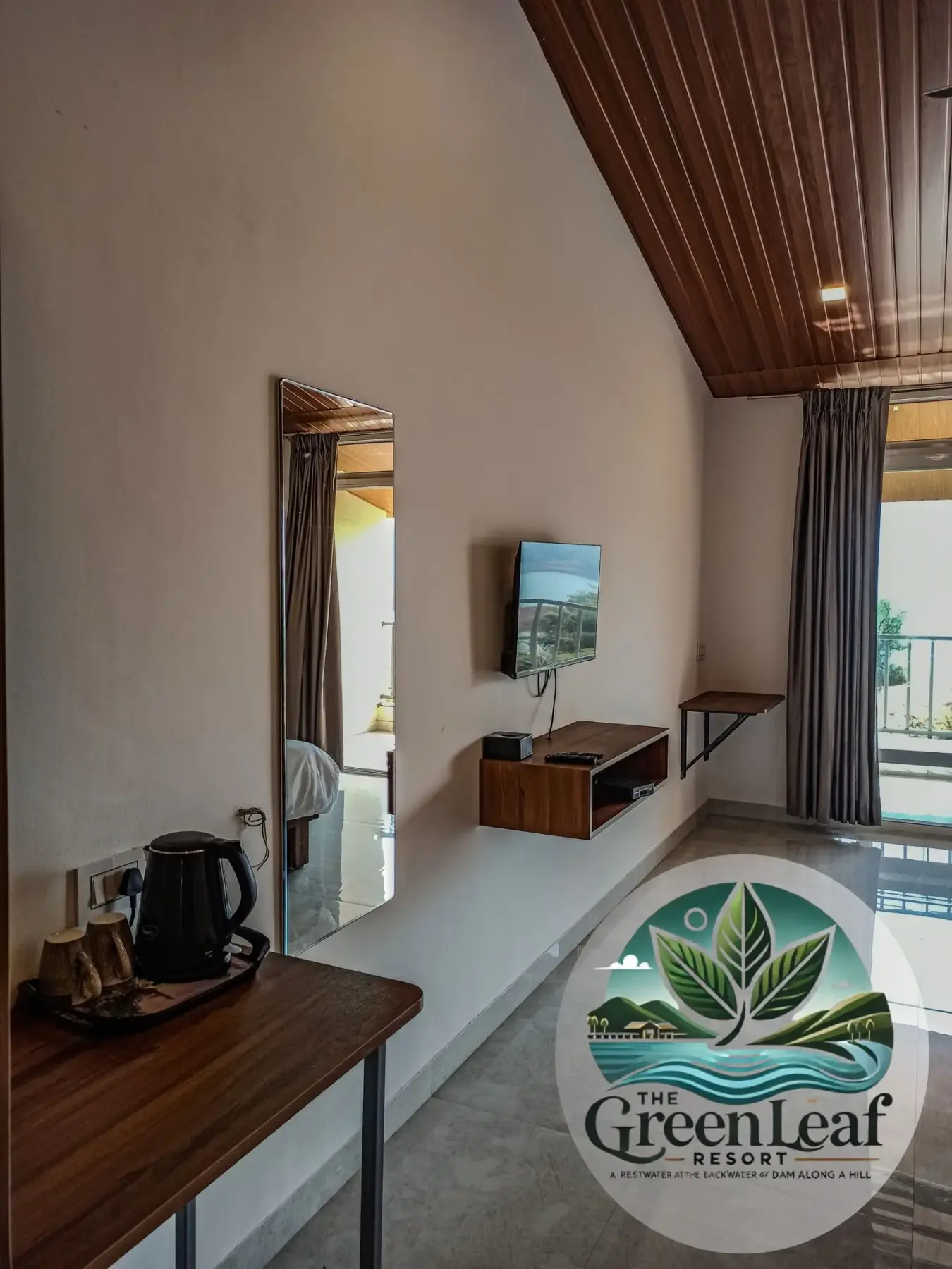 Modern resort room interior with wooden furniture and a wall-mounted TV.