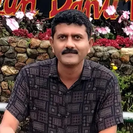 Sachin Gaikwad, a man with a mustache in a patterned shirt outdoors