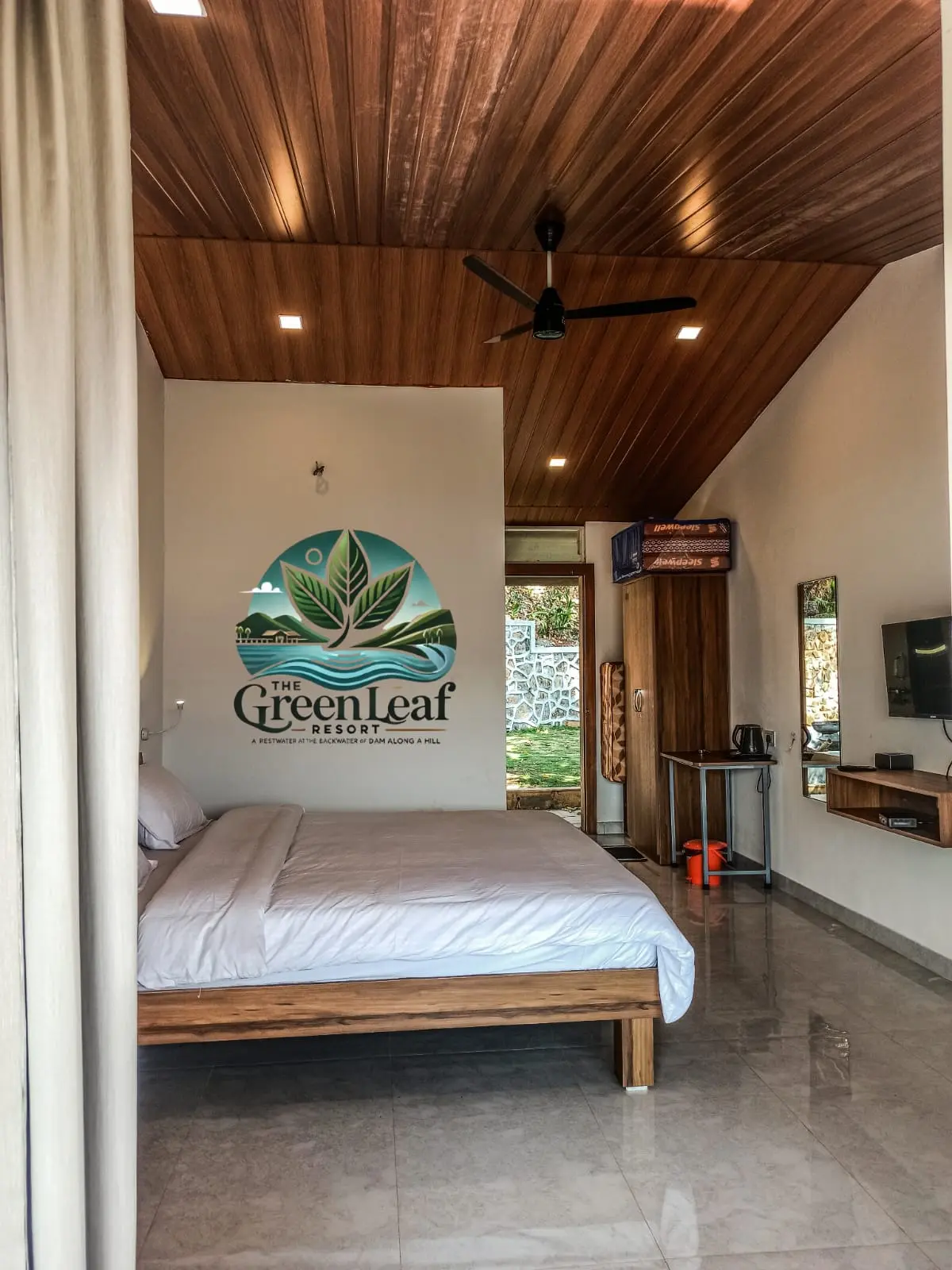 Modern, minimalistic hotel room with wooden ceiling and bed frame.