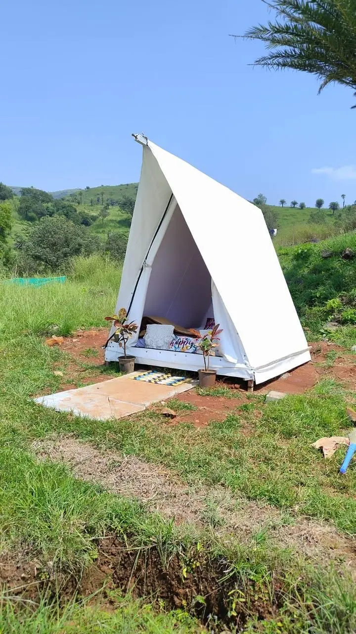 Glamping tent set on a green hillside